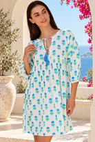 Lovebird blue cotton boho mini dress with green floral block print, tassel V-neckline and gathered empire waist