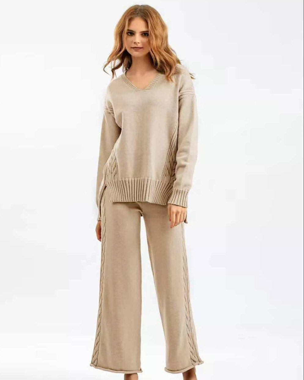 Woman wearing beige cotton cable knit lounge set with relaxed V-neck sweater and wide-leg pants - cozy boho loungewear Australia.