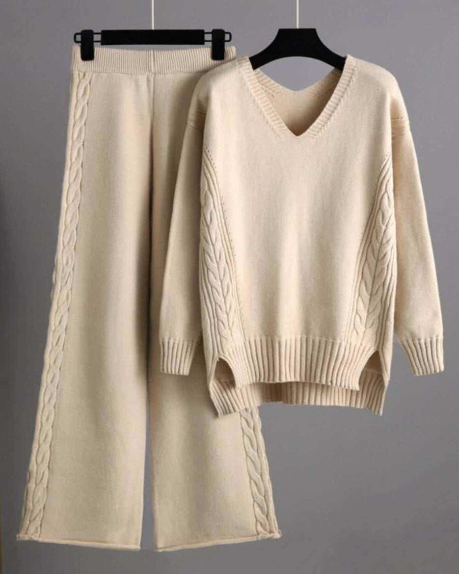 Woman wearing beige cotton cable knit lounge set with relaxed V-neck sweater and wide-leg pants - cozy boho loungewear Australia.