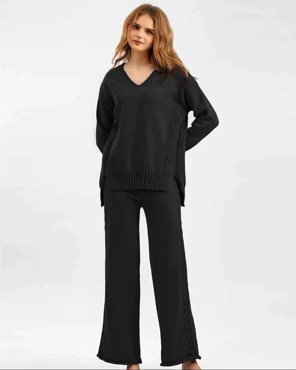 Woman wearing black cable knit lounge set with wide-leg pants and relaxed V-neck sweater —100% cotton winter knitwear.