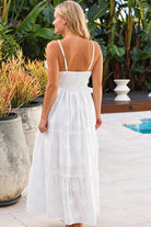 Olivia white embroidered cotton maxi dress with lace waist, tassel V-neck, adjustable straps and tiered skirt