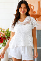 White cotton crochet top with mandala motifs scalloped sleeves and peplum hem – boho summer fashion