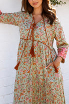 Lauren 100% cotton floral boho maxi dress in sage green with coral botanical print, tassel ties and contrast border hem