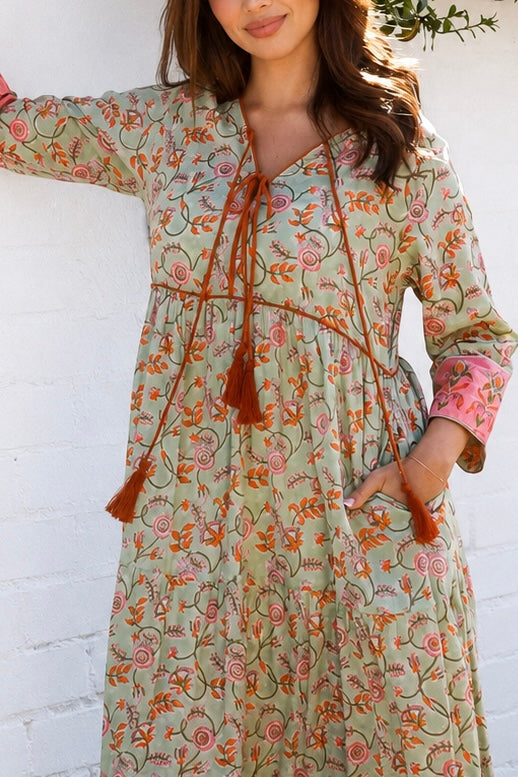 Lauren 100% cotton floral boho maxi dress in sage green with coral botanical print, tassel ties and contrast border hem