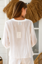 Paige white embroidered blouse by Salty Palm with floral panels, split neckline and long relaxed sleeves