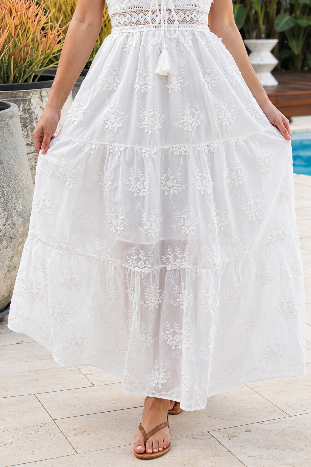 Olivia white embroidered cotton maxi dress with lace waist, tassel V-neck, adjustable straps and tiered skirt