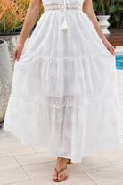 Olivia white embroidered cotton maxi dress with lace waist, tassel V-neck, adjustable straps and tiered skirt
