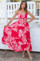 Woman wearing the Zaria Rose Maxi red floral boho maxi dress with tie straps - romantic summer fashion Australia.