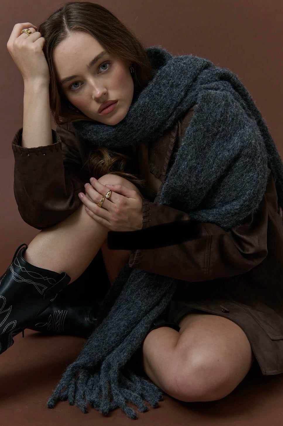 Woman wrapped in a charcoal fluffy boho wool blend scarf with fringe - The Midnight Hour winter wrap from Bohemian Love Runway.