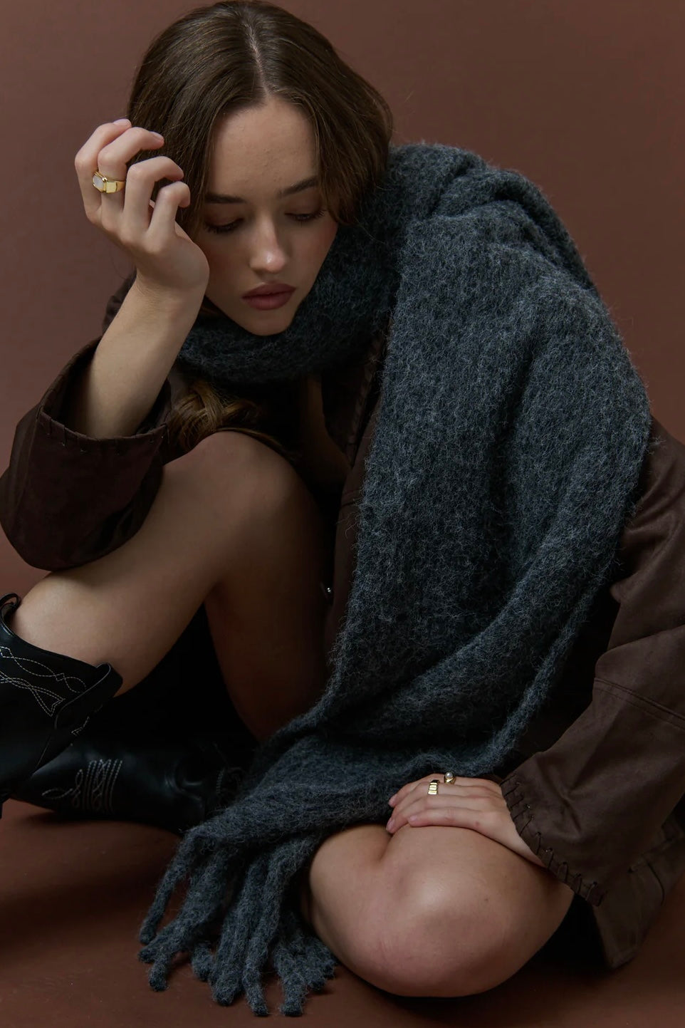 Woman wrapped in a charcoal fluffy boho wool blend scarf with fringe - The Midnight Hour winter wrap from Bohemian Love Runway.