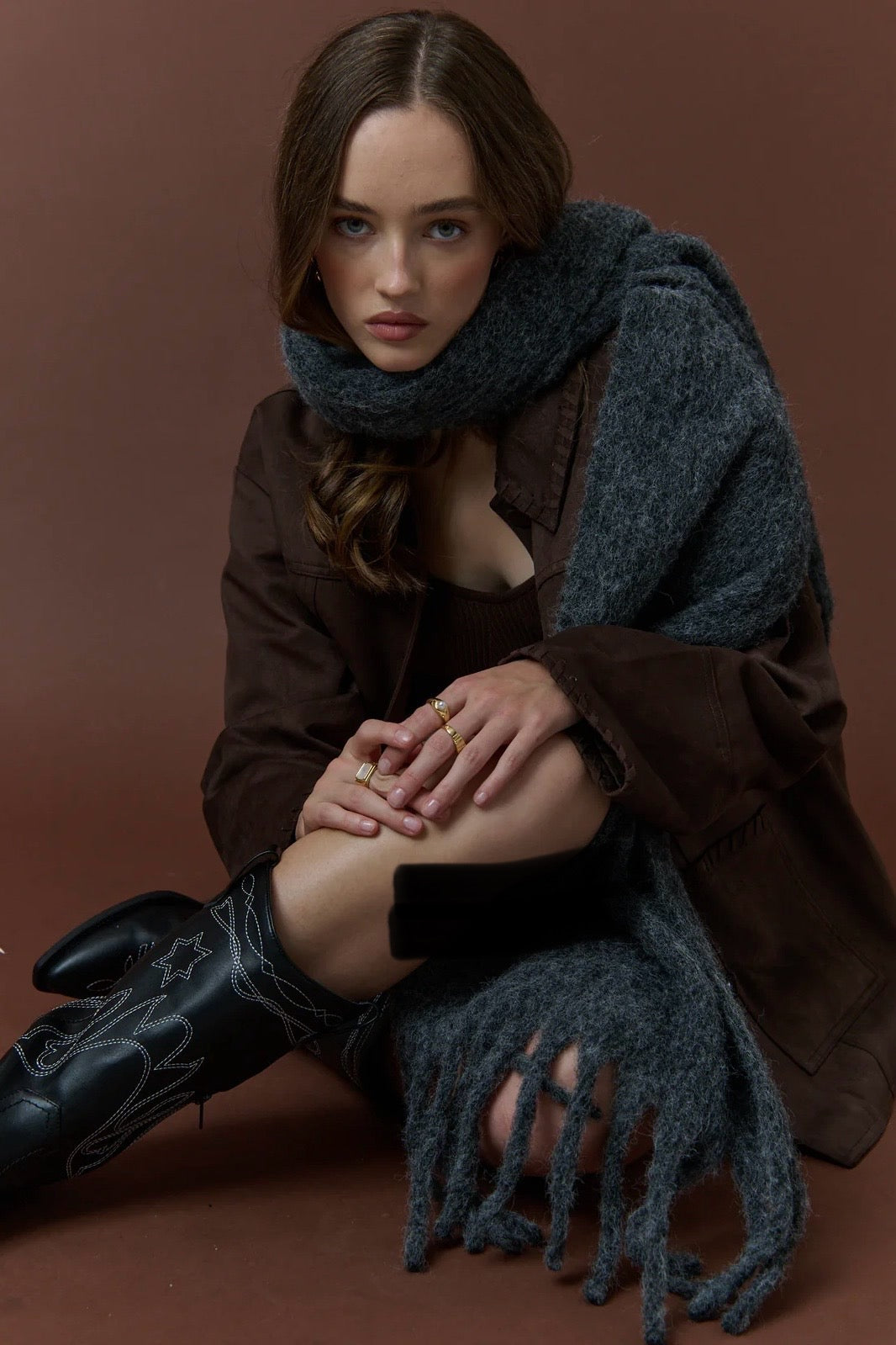 Woman wrapped in a charcoal fluffy boho wool blend scarf with fringe - The Midnight Hour winter wrap from Bohemian Love Runway.