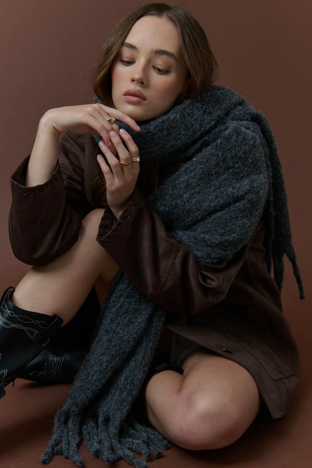 Woman wrapped in a charcoal fluffy boho wool blend scarf with fringe - The Midnight Hour winter wrap from Bohemian Love Runway.