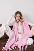 Woman in a soft blush pink boho scarf with tassels styled over a knit jumper - Rosabella scarf Australia.