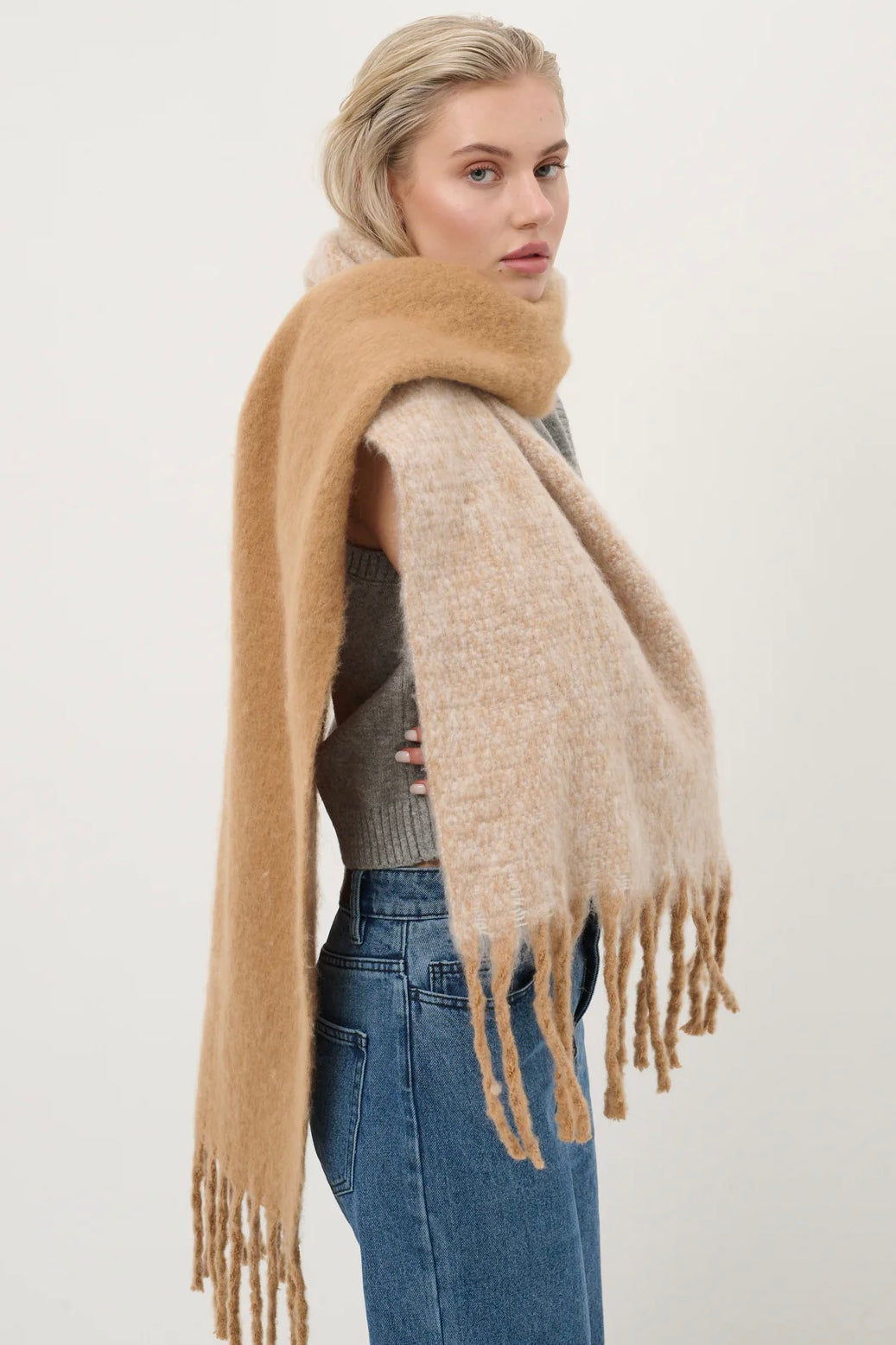 Woman wearing a caramel and beige fluffy boho scarf with fringe - Amber Light soft winter wrap by Bohemian Love Runway.