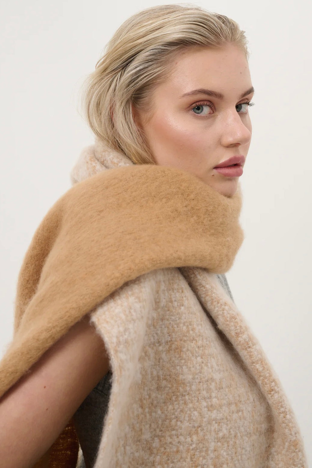 Woman wearing a caramel and beige fluffy boho scarf with fringe - Amber Light soft winter wrap by Bohemian Love Runway.