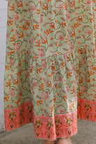 Lauren 100% cotton floral boho maxi dress in sage green with coral botanical print, tassel ties and contrast border hem