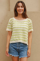 Woman wearing lime and cream crochet cotton top with vintage pattern and denim shorts - boho summer fashion Australia.