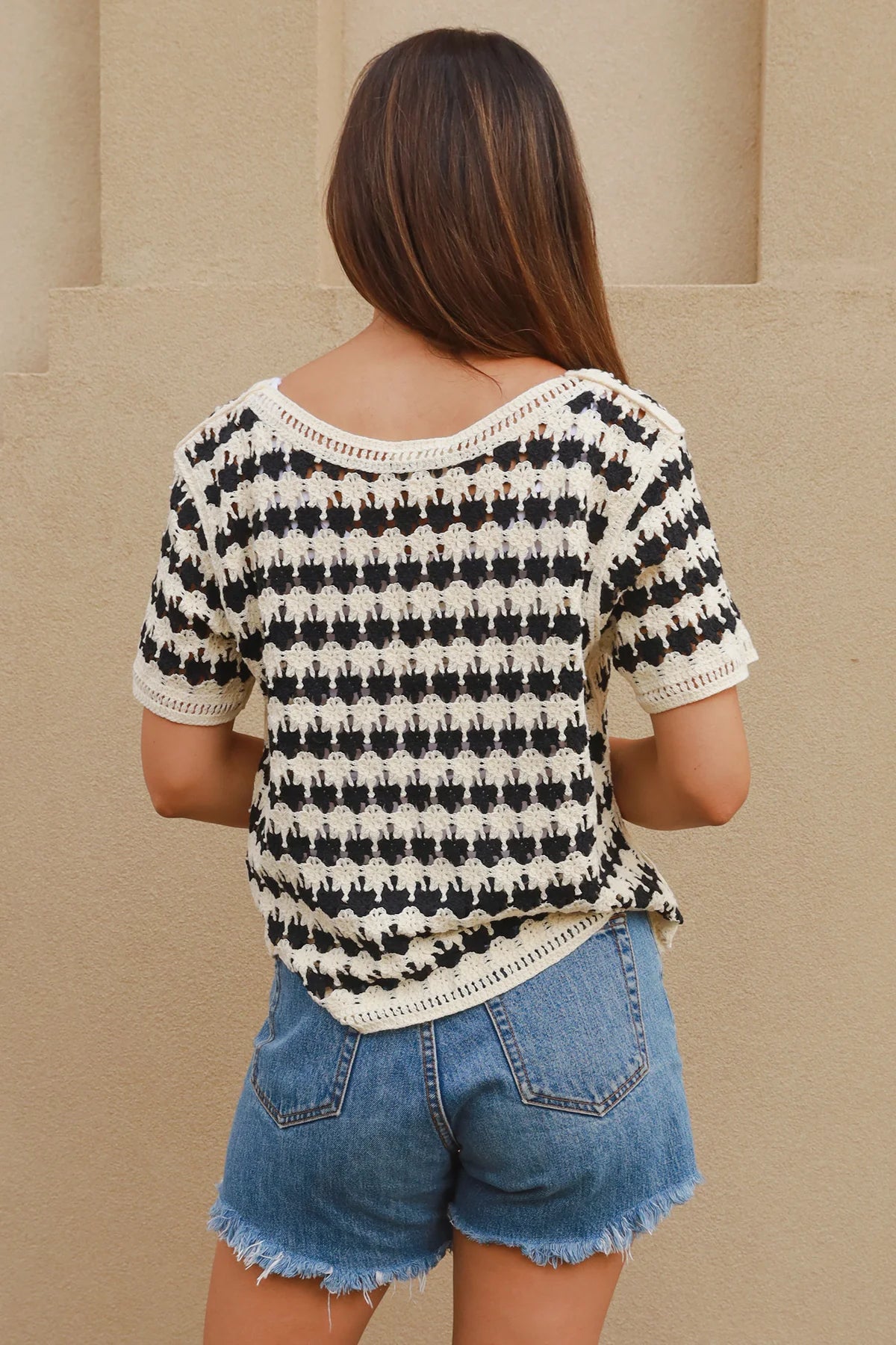 Woman wearing black and cream crochet cotton top with checkerboards pattern - boho summer fashion Australia.