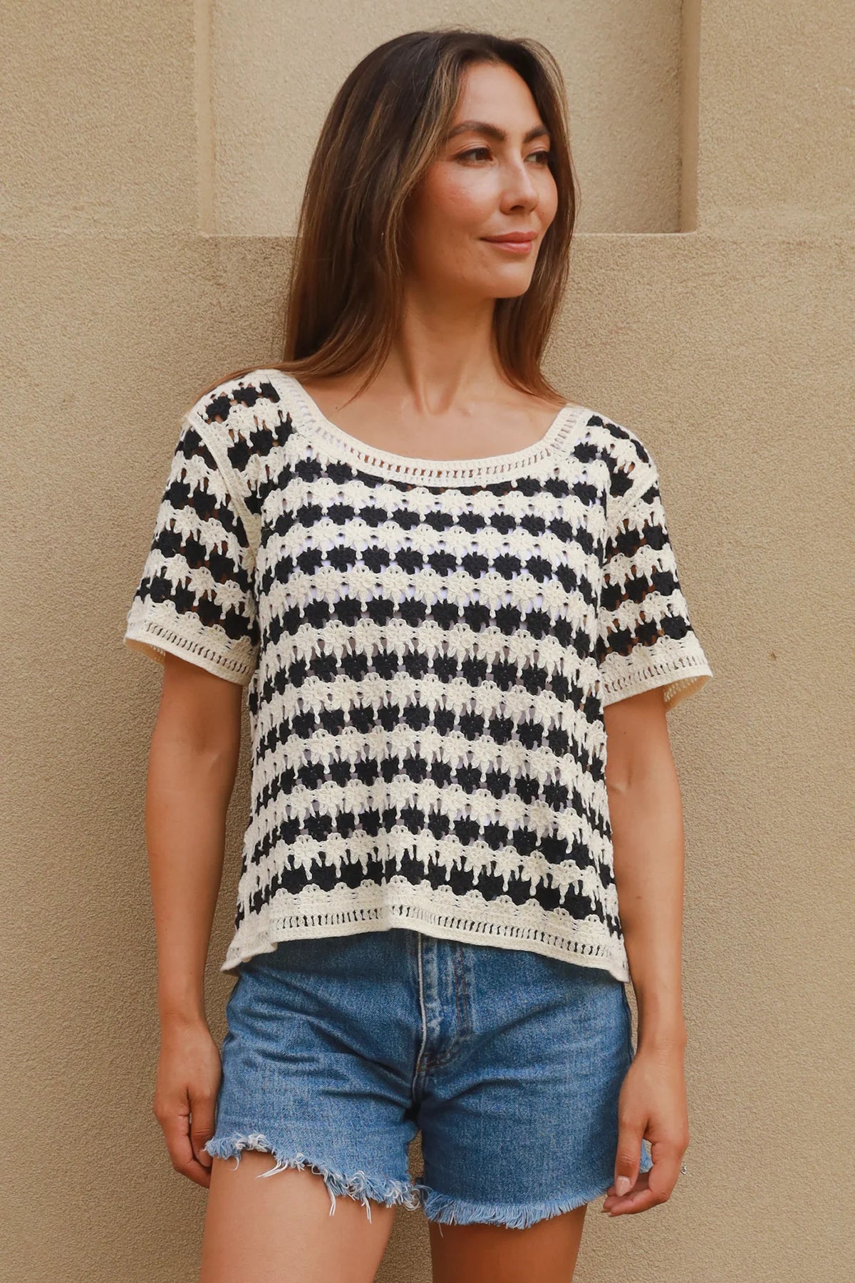Woman wearing black and cream crochet cotton top with checkerboards pattern - boho summer fashion Australia.