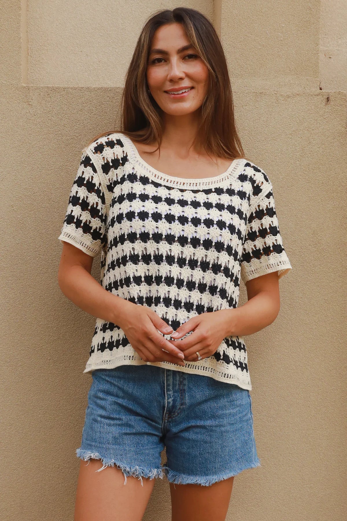 Woman wearing black and cream crochet cotton top with checkerboards pattern - boho summer fashion Australia.