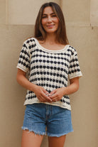 Woman wearing black and cream crochet cotton top with checkerboards pattern - boho summer fashion Australia.