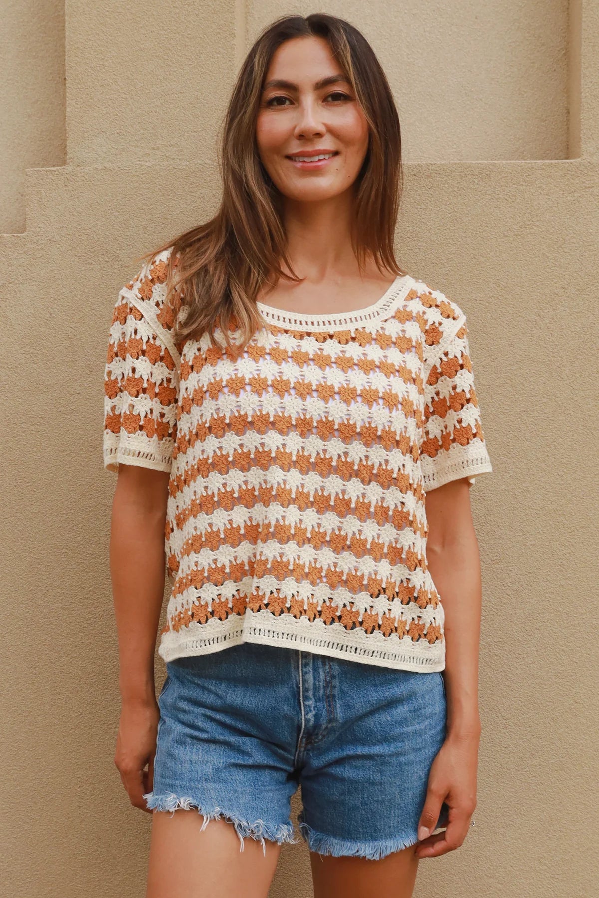 Woman wearing cram and tan crochet cotton top with boho vintage pattern - indie summer fashion Australia.