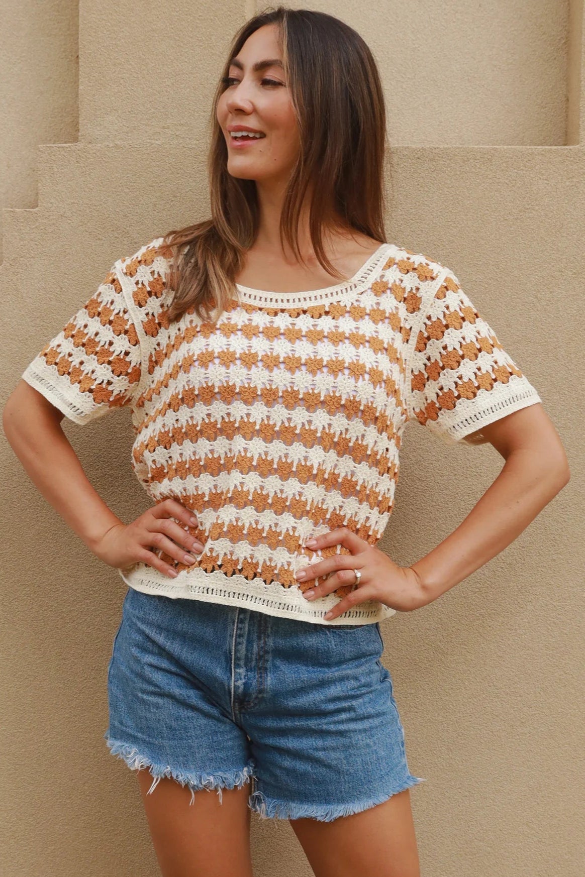 Woman wearing cram and tan crochet cotton top with boho vintage pattern - indie summer fashion Australia.
