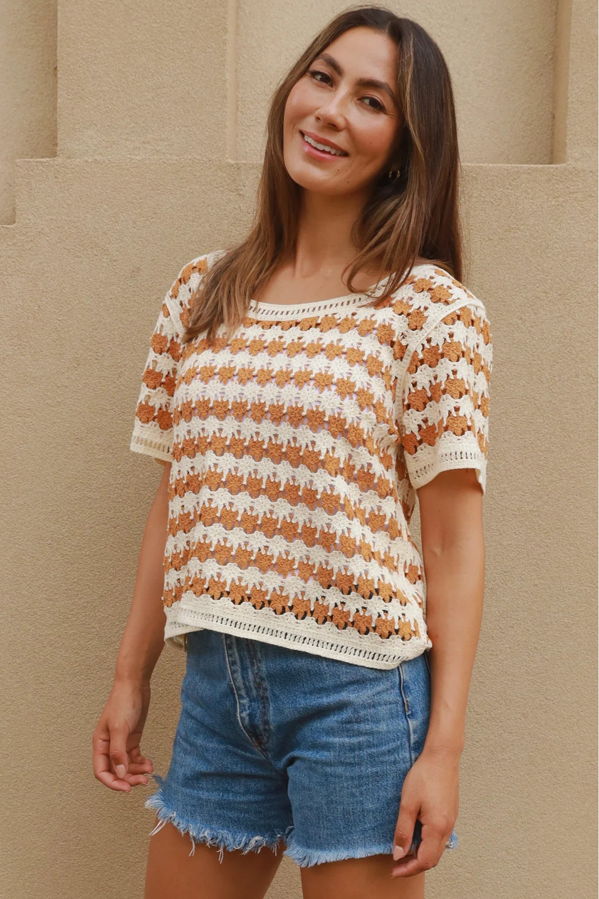 Woman wearing cram and tan crochet cotton top with boho vintage pattern - indie summer fashion Australia.