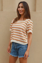 Woman wearing cram and tan crochet cotton top with boho vintage pattern - indie summer fashion Australia.