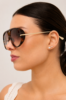 Woman wearing Jacqueline oversized aviator sunglasses in brown tortoiseshell with gradient lenses