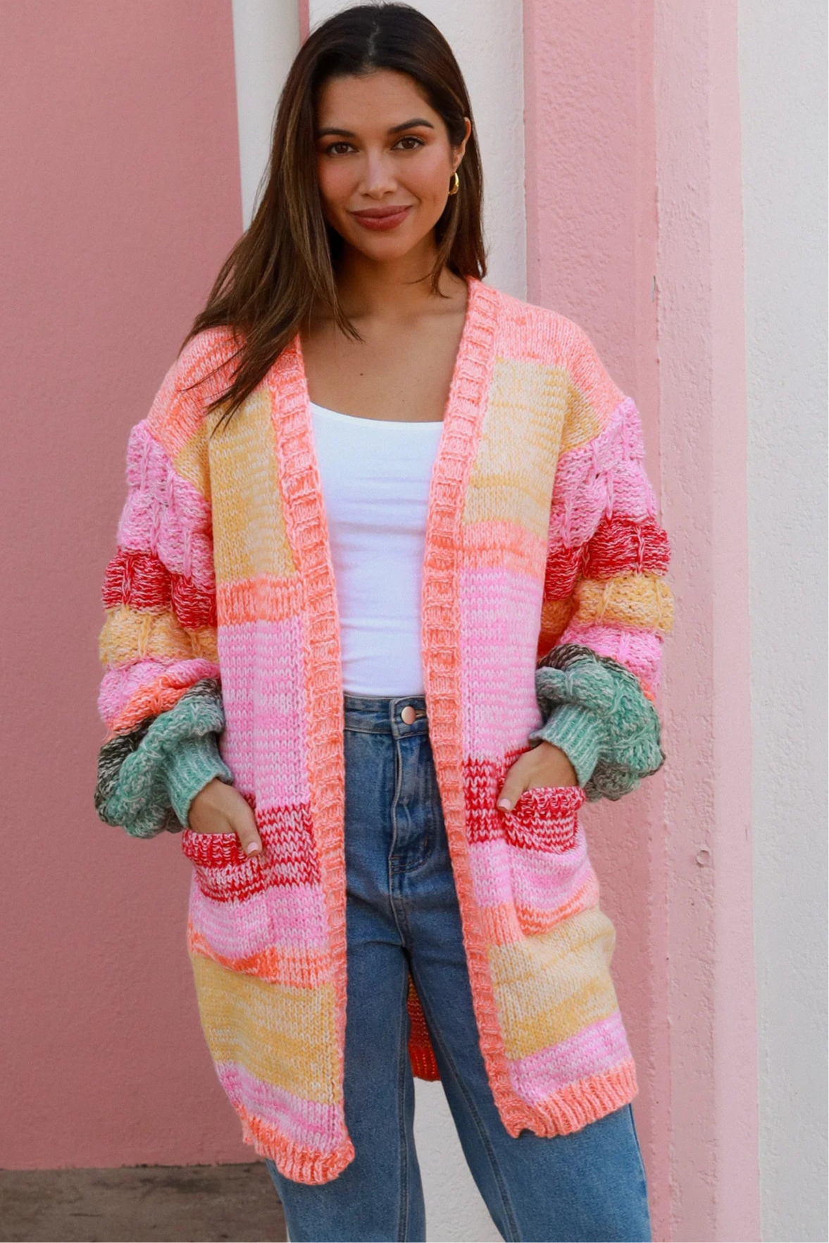Woman in a colourful chunky knit Boho cardigan with stripes and oversized sleeves - boho knitwear Australia.