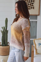 Woman wearing honey mocha cream ombre knit jumper with relaxed V neckline and soft textured winter knit