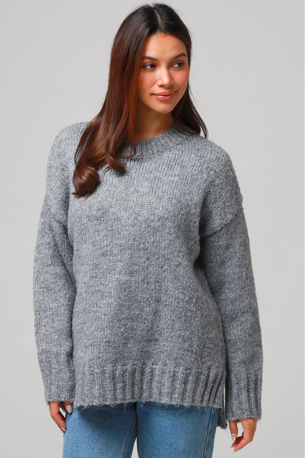 Woman wearing a grey wool blend knit jumper with ribbed cuffs and hem- boho winter jumper Australia.