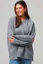 Woman wearing a grey wool blend knit jumper with ribbed cuffs and hem- boho winter jumper Australia.