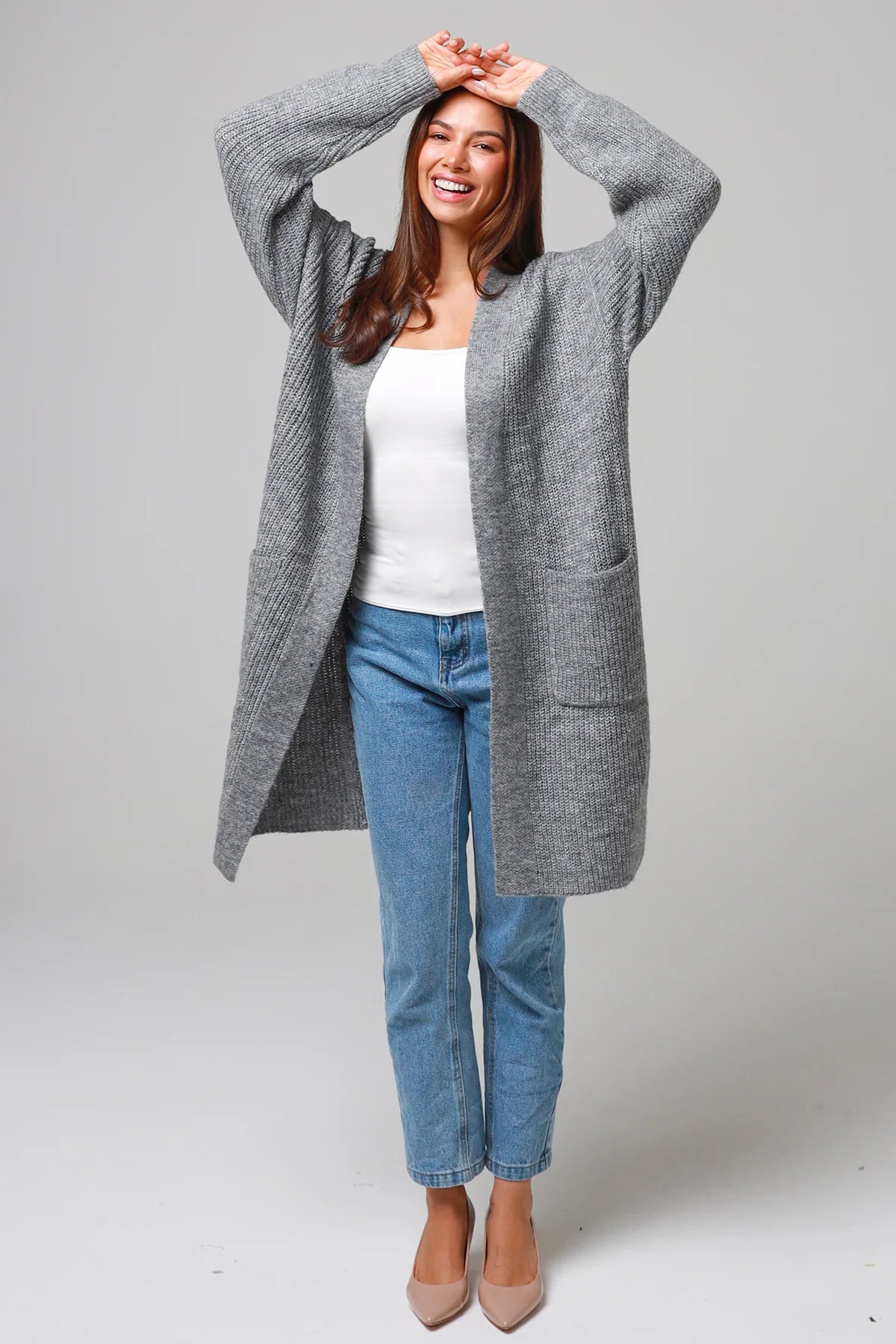 Women wearing a grey longline knit cardigan with pockets and jeans - soft boho wool blend knitwear Australia.