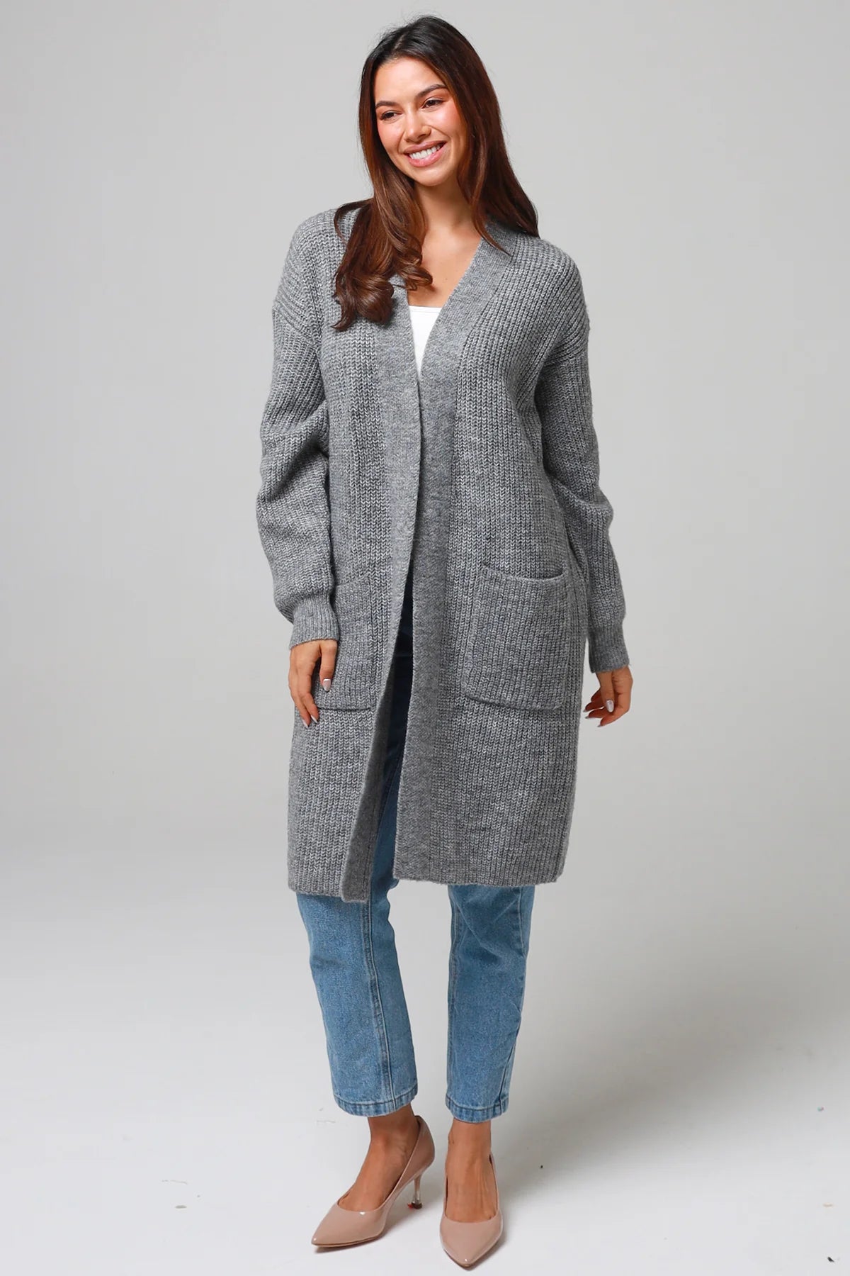 Women wearing a grey longline knit cardigan with pockets and jeans - soft boho wool blend knitwear Australia.