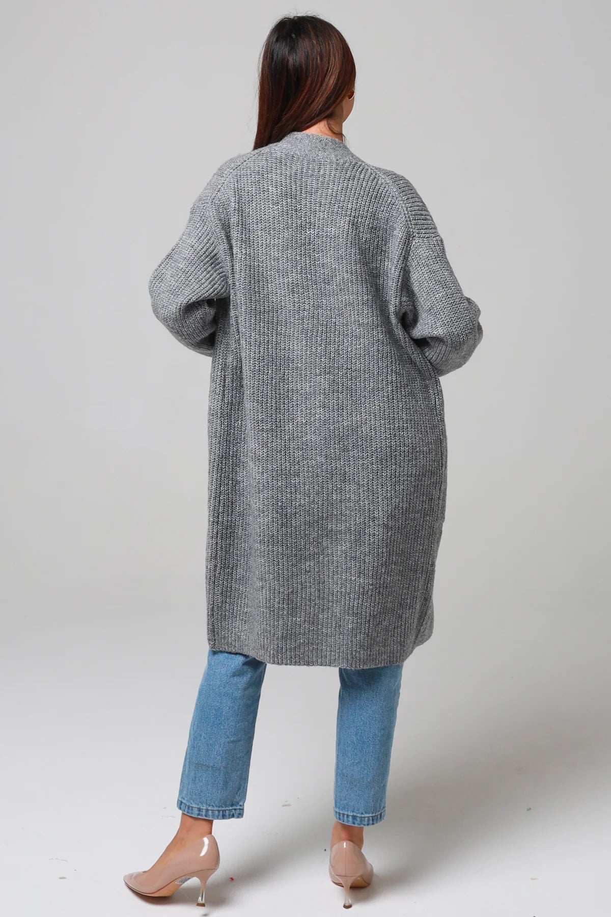 Women wearing a grey longline knit cardigan with pockets and jeans - soft boho wool blend knitwear Australia.