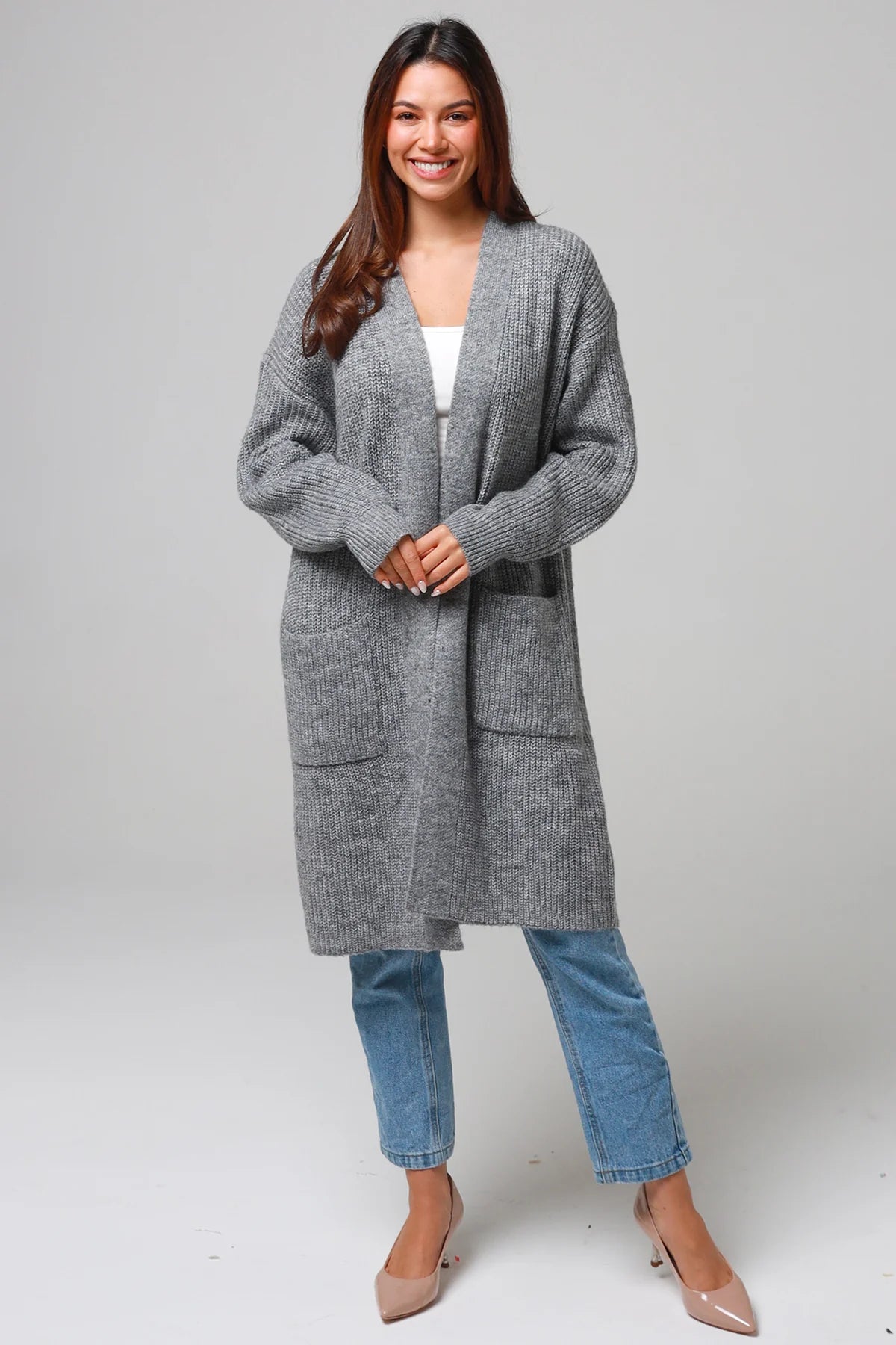 Women wearing a grey longline knit cardigan with pockets and jeans - soft boho wool blend knitwear Australia.