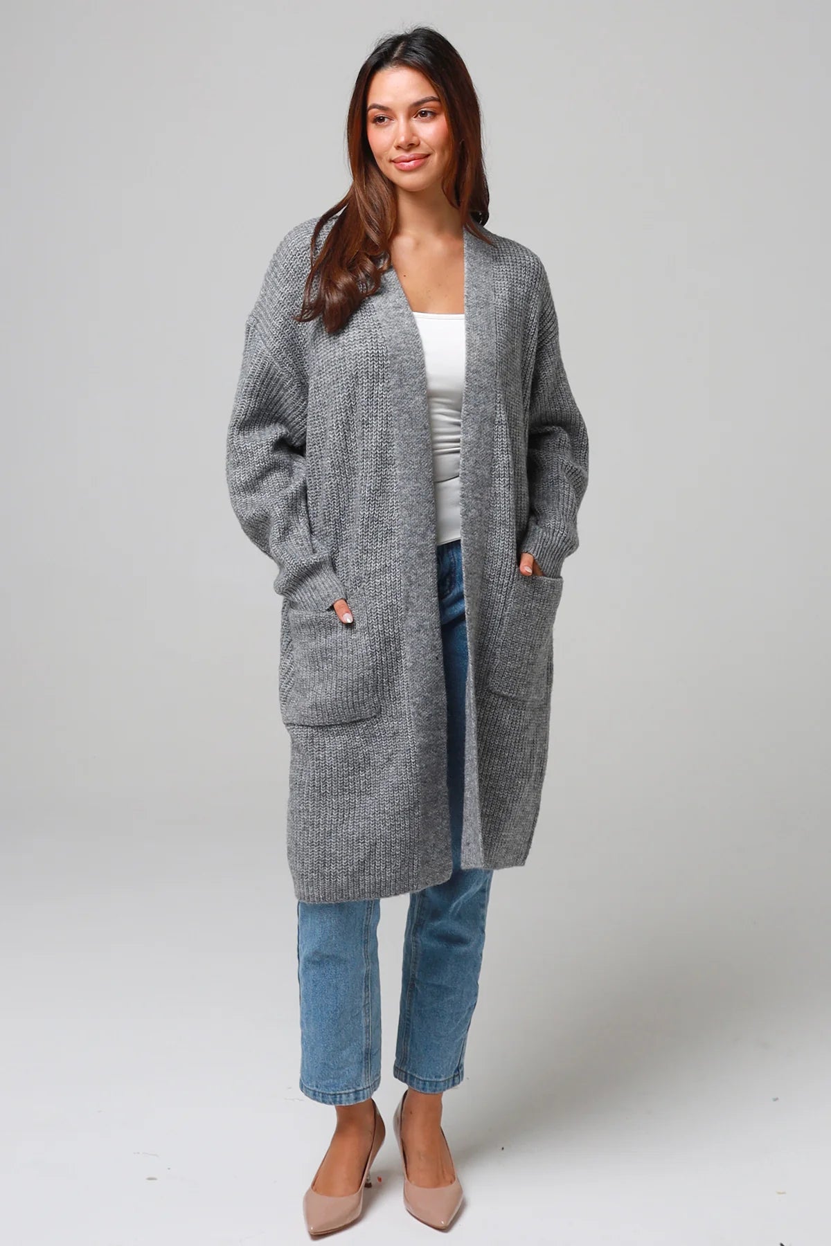 Women wearing a grey longline knit cardigan with pockets and jeans - soft boho wool blend knitwear Australia.