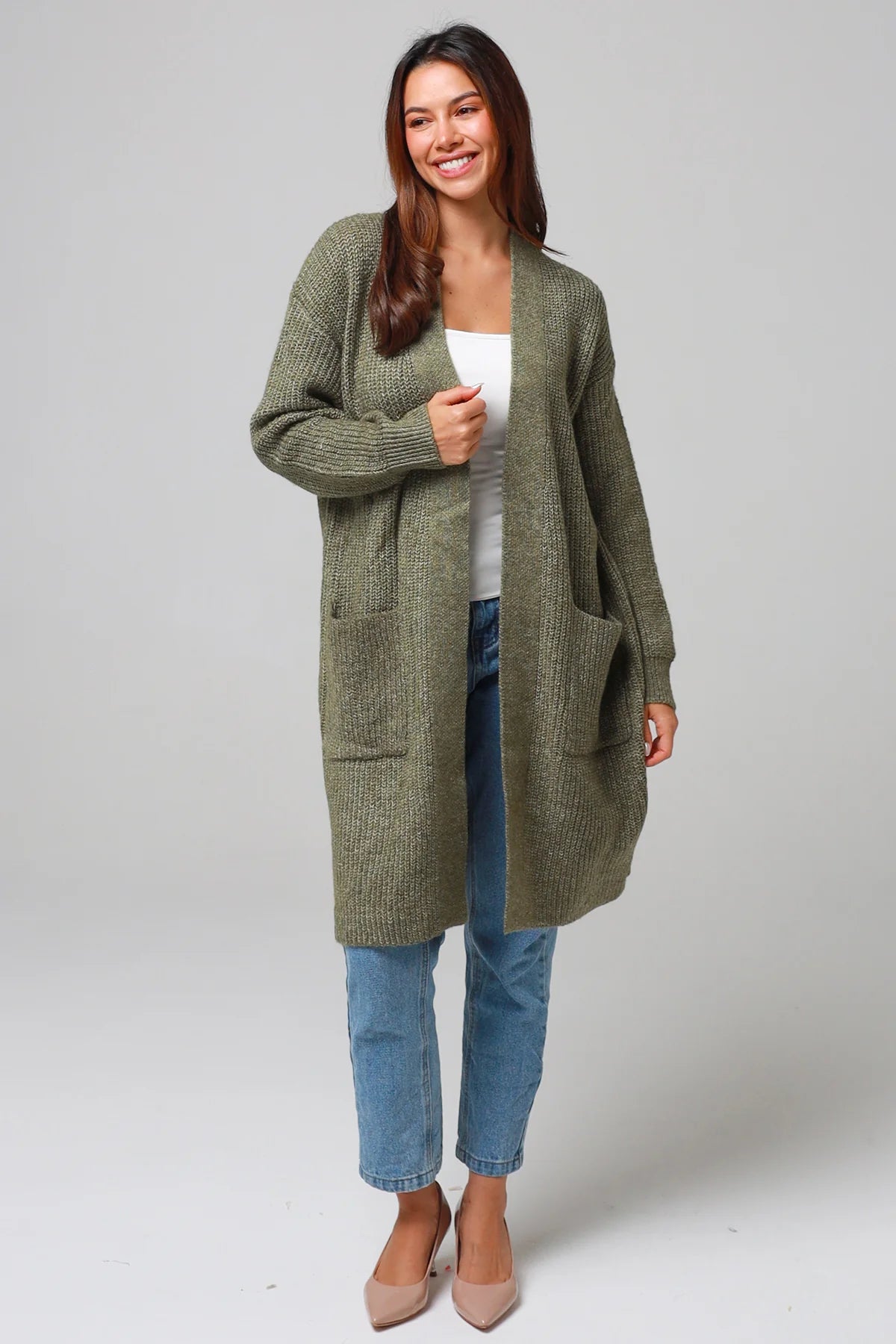 Woman in Khaki longline cardigan with patch pockets and denim - earthy boho wool blend knitwear Australia.