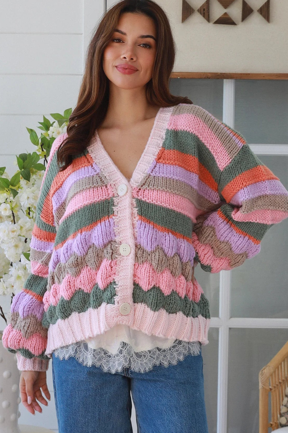 Woman wearing colourful textured wool blend knit cardigan with balloon sleeves and relaxed boho winter styling
