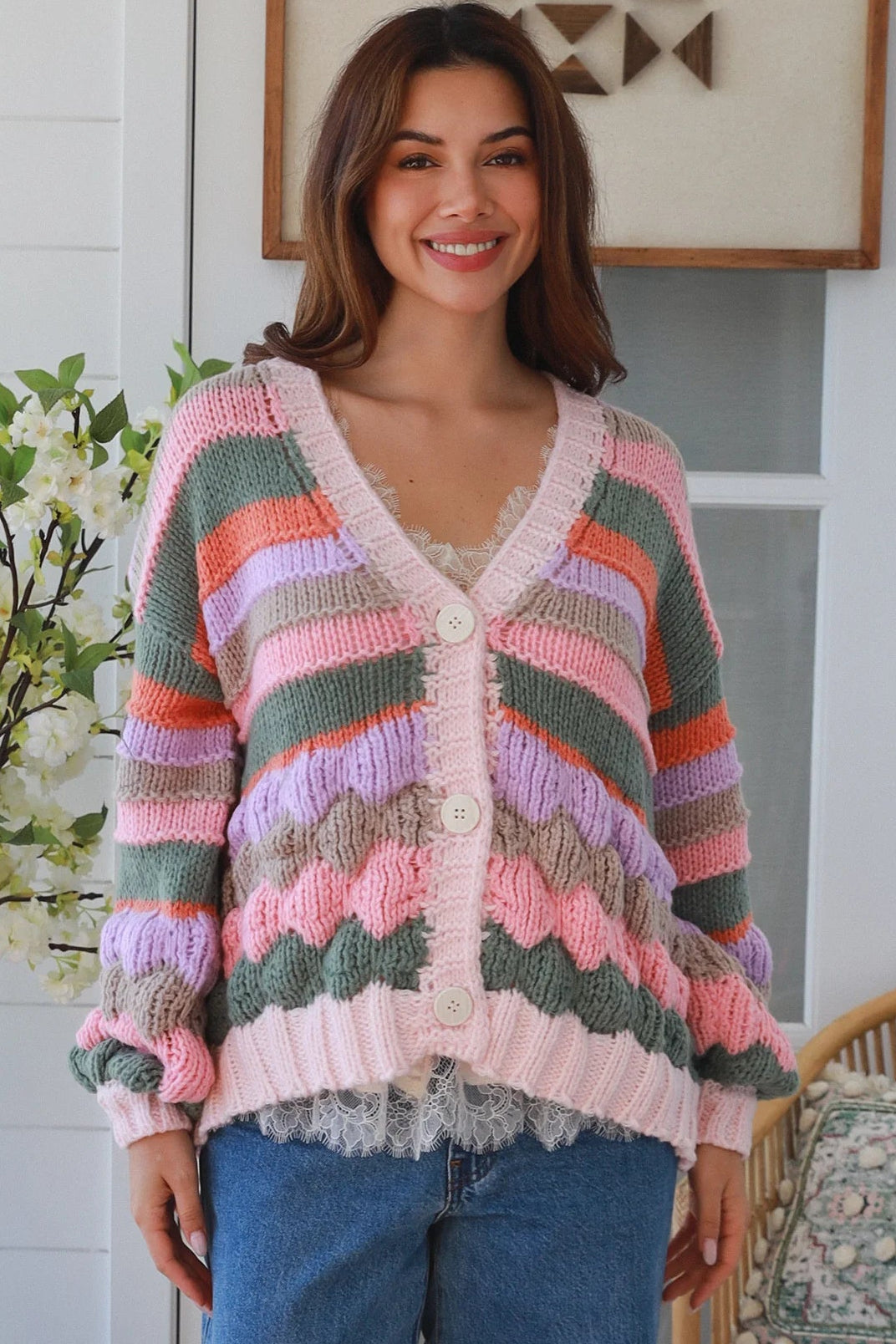 Woman wearing colourful textured wool blend knit cardigan with balloon sleeves and relaxed boho winter styling