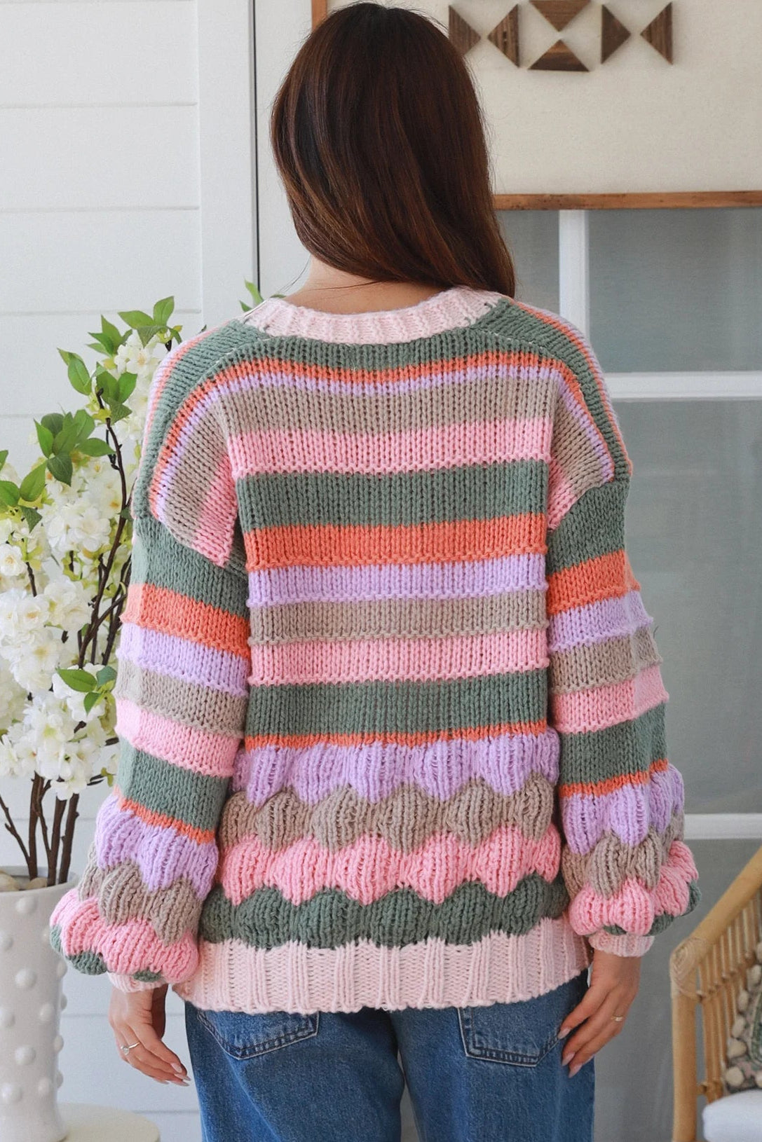 Woman wearing colourful textured wool blend knit cardigan with balloon sleeves and relaxed boho winter styling