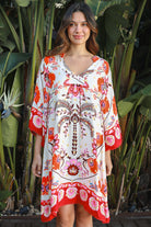 Woman wearing a ruby + blush floral boho mini dress with kimono sleeves + scalloped hem — Ruby Palm Dreamcatcher