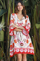 Woman wearing a ruby + blush floral boho mini dress with kimono sleeves + scalloped hem — Ruby Palm Dreamcatcher