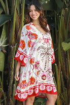 Woman wearing a ruby + blush floral boho mini dress with kimono sleeves + scalloped hem — Ruby Palm Dreamcatcher