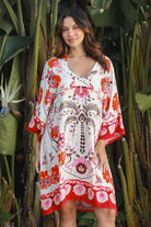 Woman wearing a ruby + blush floral boho mini dress with kimono sleeves + scalloped hem — Ruby Palm Dreamcatcher