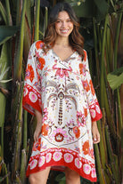 Woman wearing a ruby + blush floral boho mini dress with kimono sleeves + scalloped hem — Ruby Palm Dreamcatcher