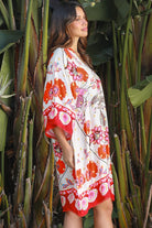 Woman wearing a ruby + blush floral boho mini dress with kimono sleeves + scalloped hem — Ruby Palm Dreamcatcher