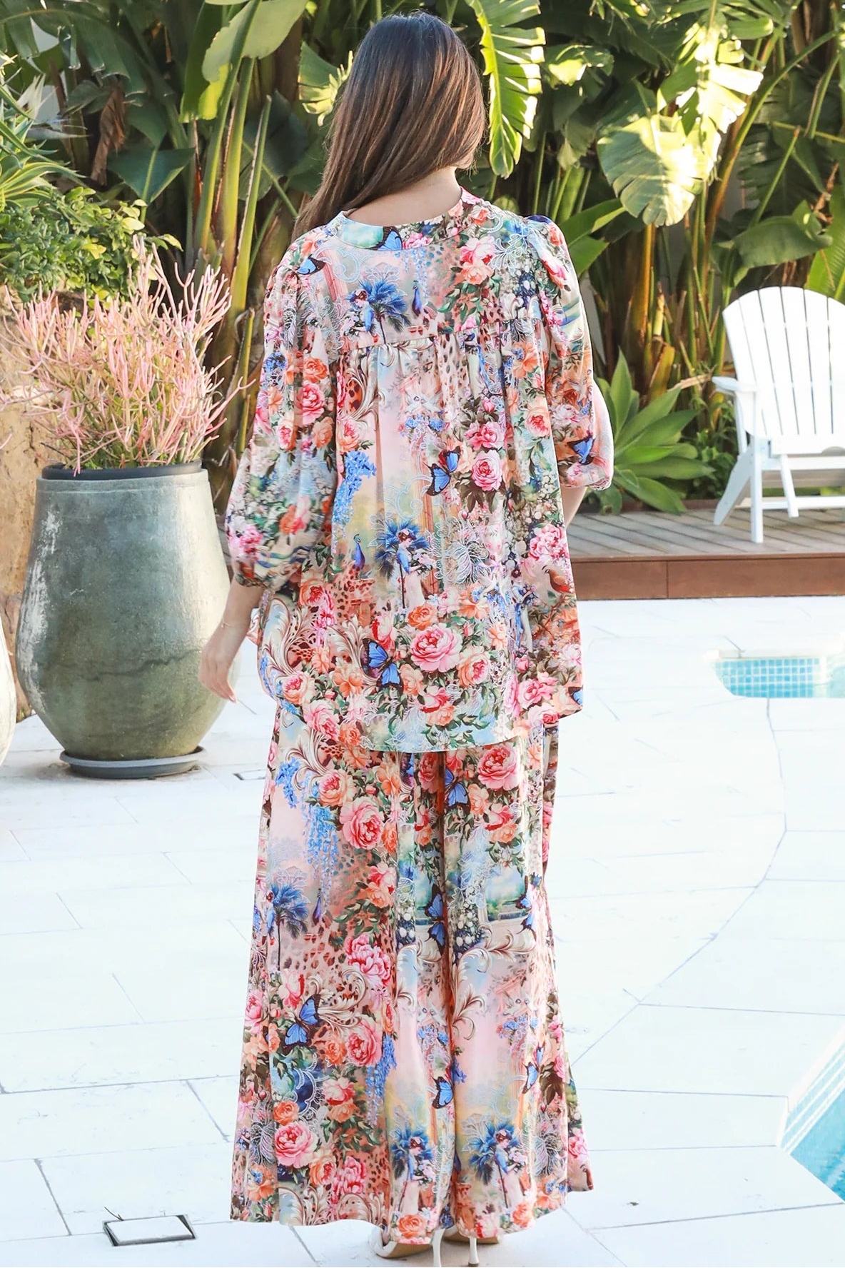 Woman wearing Hannah Blouse in soft rayon with three quarter elastic sleeves and gathered back yoke boho style